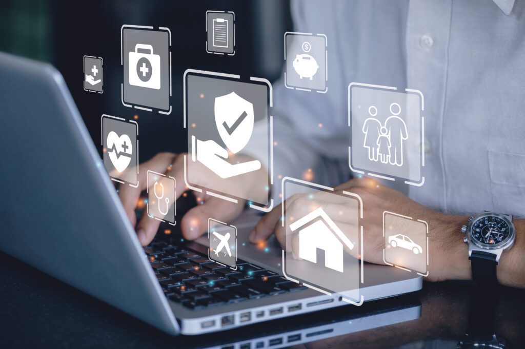 A close shot of a person at a laptop, with images that illustrate security and technology over it